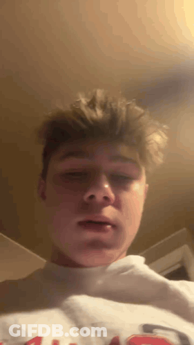 Young Man In White Sweatshirt With Letter G GIF