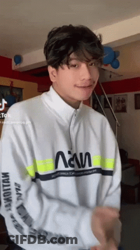 Young Man In White Sweatshirt With Yellow Stripe Dancing GIF