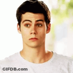 Young Man In White T-Shirt Looking At Camera GIF