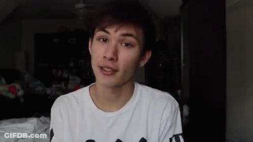 Young Man In White T-Shirt Talking To Camera GIF