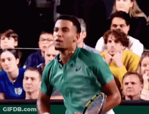 Young Man In White Tank Top Looking Down In Store GIF