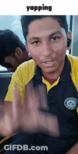 Young Man In Yellow And Black Shirt Making Stop Gesture GIF