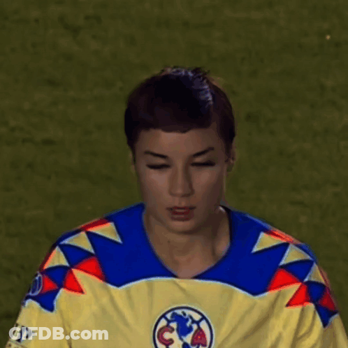 Young Man In Yellow And Blue Jersey With Soccer Ball GIF