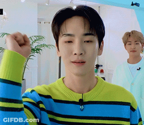 Young Man In Yellow And Blue Striped Sweater Making Fist GIF
