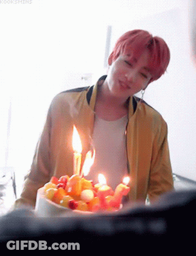 Young Man In Yellow Jacket With Birthday Cake GIF