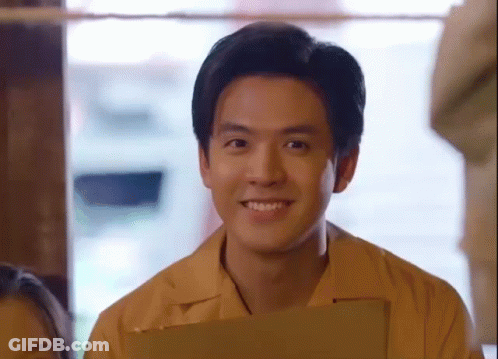 Young Man In Yellow Shirt Holding Clipboard GIF