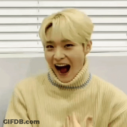 Young Man In Yellow Sweater Making Funny Face GIF
