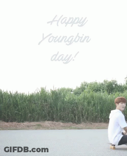 Young Man Kneeling On Skateboard Saying Happy Youngbin Day GIF