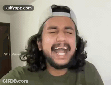 Young Man Laughing With Glasses And Purple Shirt GIF