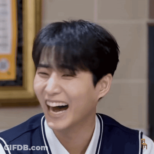 Young Man Laughing With Letter E On Chest GIF