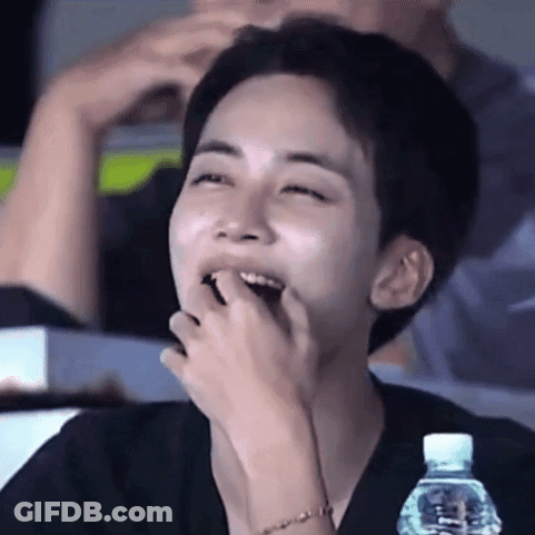 Young Man Laughing With Water Bottle In Stadium GIF
