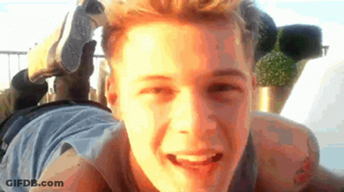 Young Man Laying With Converse Shoe On Head GIF