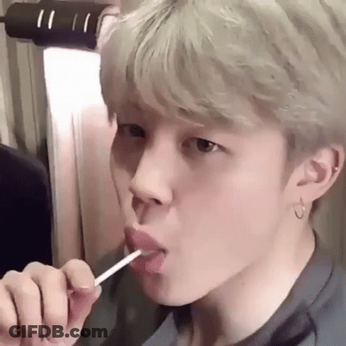 Young Man Licking Lollipop GIF