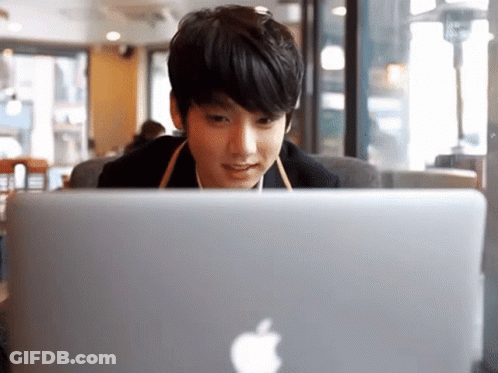 Young Man Looking At Apple Laptop GIF