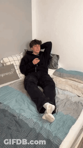 Young Man Lying On Bed With Menschen Pillow GIF