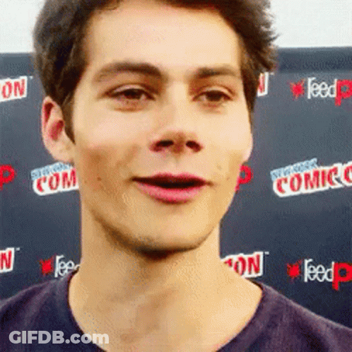 Young Man Making Funny Face At Comic Con Wall GIF