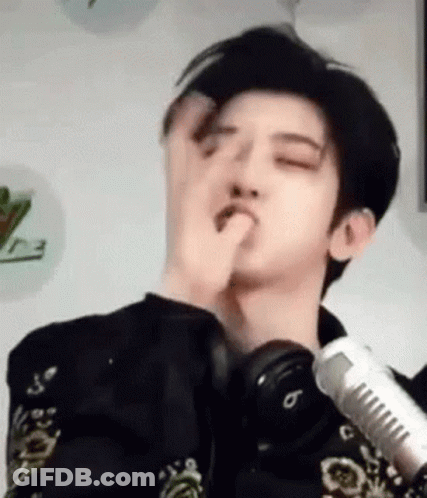 Young Man Making Funny Face At Microphone With Headphones GIF