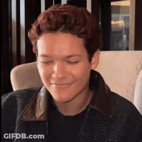 Young Man Making Funny Face In Chair GIF