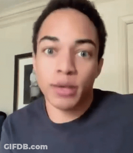 Young Man Making Funny Face Looking At Camera GIF