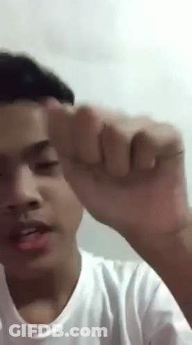 Young Man Making Funny Face With Fist Up GIF