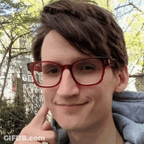 Young Man Making Funny Face With Glasses And Blue Hoodie GIF