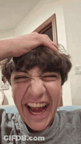 Young Man Making Funny Face With Hand On Head GIF