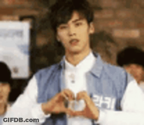 Young Man Making Heart Shape With Hands GIF
