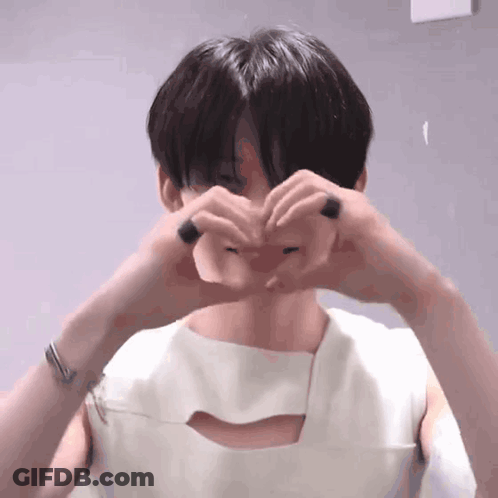 Young Man Making Heart Shape With Hands GIF