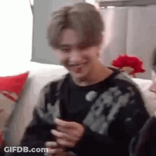 Young Man On Couch Holding Phone Making Funny Face GIF