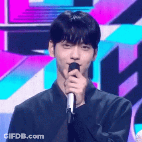 Young Man On Stage With Colorful Background GIF