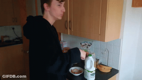 Young Man Pouring Milk Into Bowl GIF