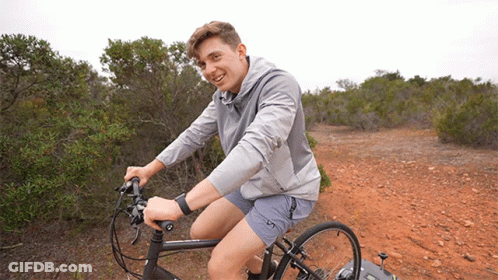 Young Man Riding Bike On Dirt Path GIF