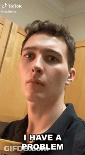 Young Man Says I Have A Problem In Front Of Wooden Cabinet GIF