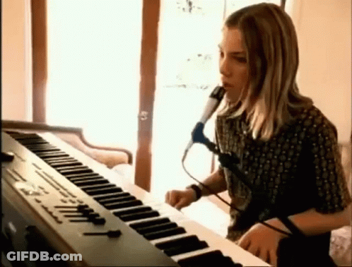 Young Man Singing Into Microphone Playing Keyboard GIF