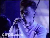 Young Man Singing Into Microphone Purple Shirt GIF