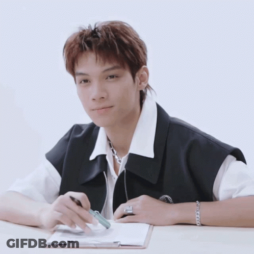 Young Man Sitting At Desk With Clipboard GIF