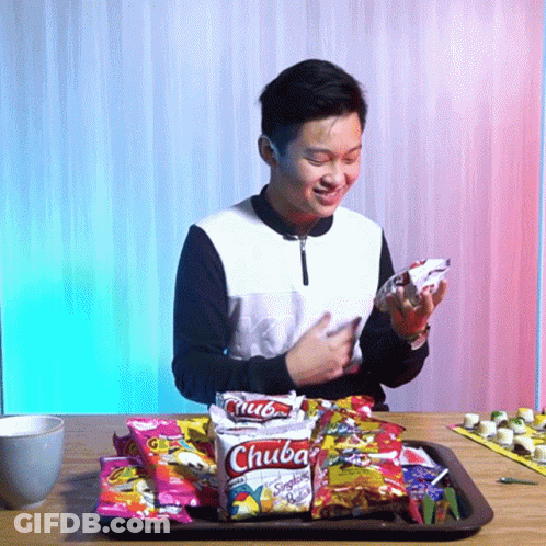 Young Man Sitting At Table With Chuba Snacks Saying Wow GIF
