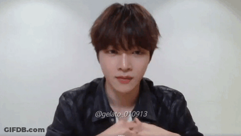 Young Man Sitting At Table With Hands Folded GIF