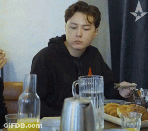 Young Man Sitting At Table With Plate Of Food GIF