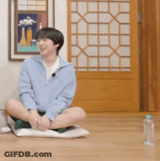 Young Man Sitting Crossed Legs With Water Bottle GIF