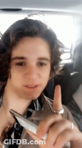 Young Man Sitting In Car Holding Phone GIF