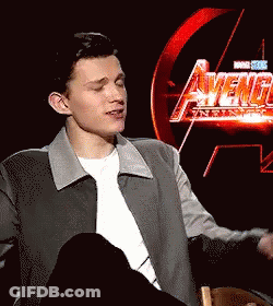 Young Man Sitting In Front Of Avengers Age Of Ultron Sign GIF