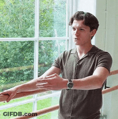 Young Man Sitting In Front Of Avengers Age Of Ultron Sign GIF