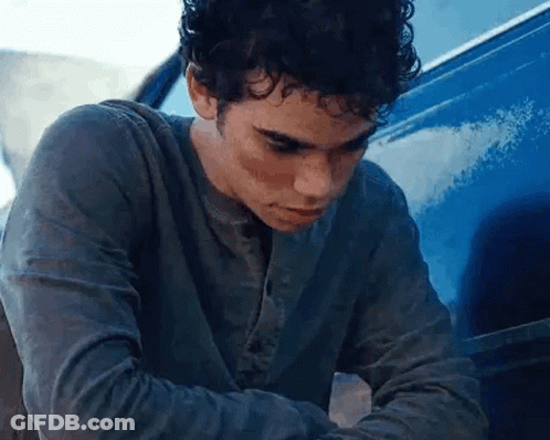 Young Man Sitting In Front Of Blue Van GIF