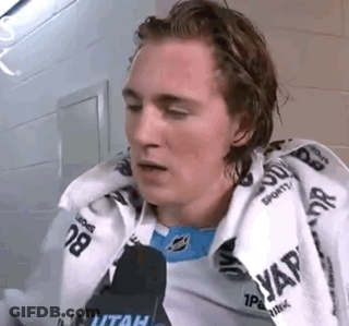 Young Man Sitting In Locker Room With Towel And Microphone GIF