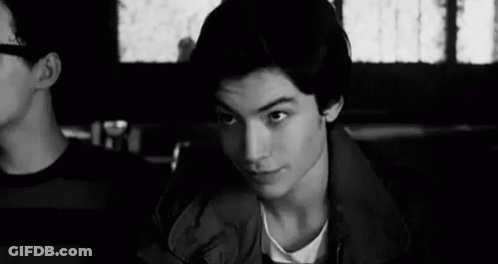 Young Man Sitting In Restaurant GIF