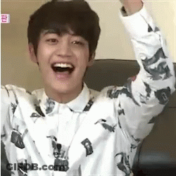 Young Man Sitting Laughing With Arms Up GIF