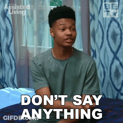 Young Man Sitting On Bed Saying Don't Say Anything GIF