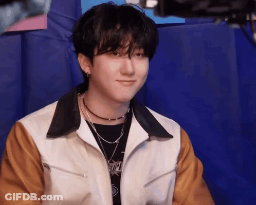 Young Man Sitting On Blue Cushion GIF