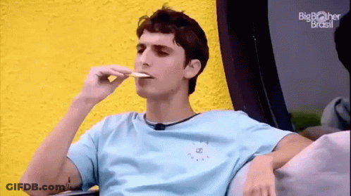 Young Man Sitting On Couch Eating Food GIF